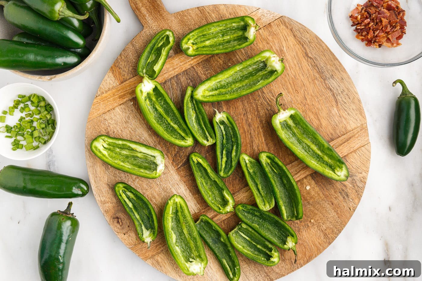deseeded jalapeno peppers on a cutting board