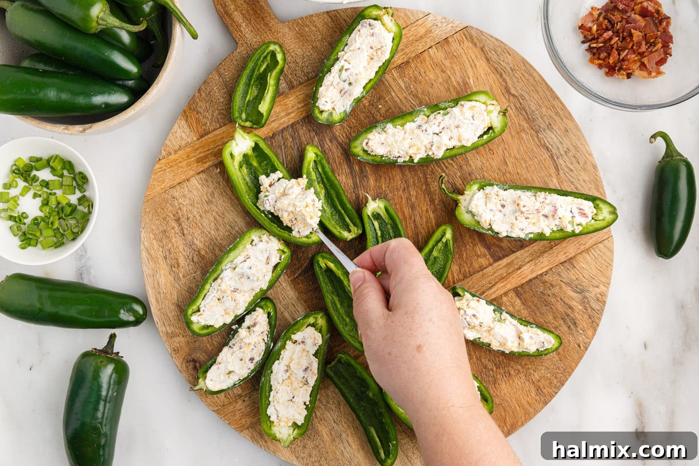 stuffing jalapeno pepper slices with cream cheese filling
