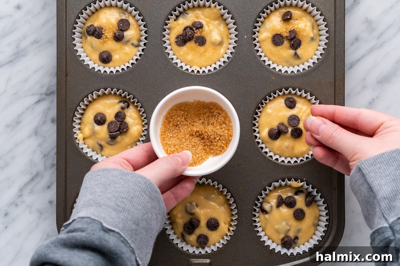 Sprinkling sugar in the raw on top of muffin batter for an optional crunchy topping