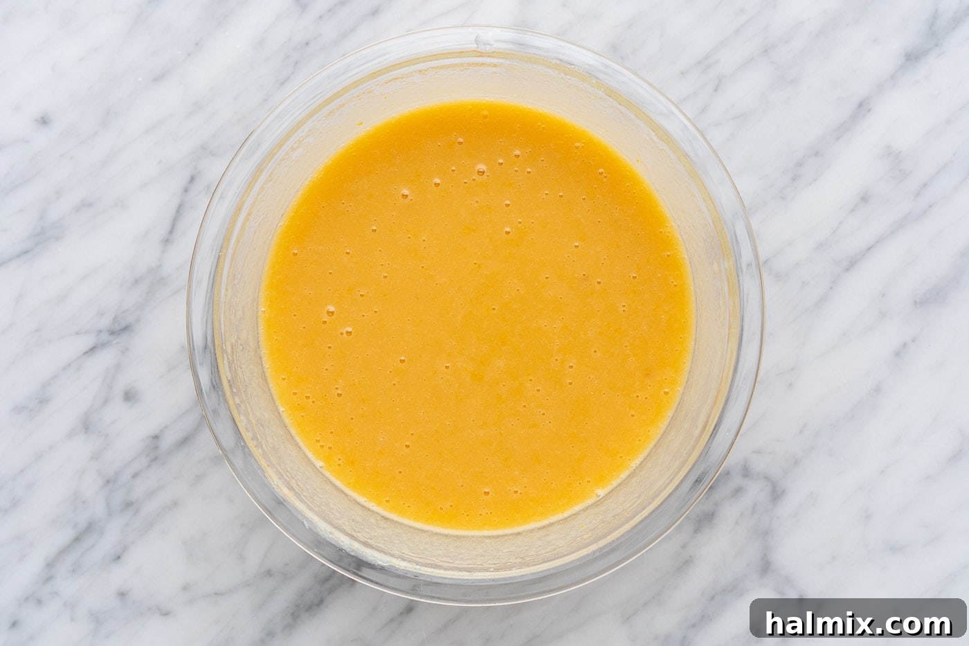 The fully combined, smooth wet ingredients for muffin batter in a bowl