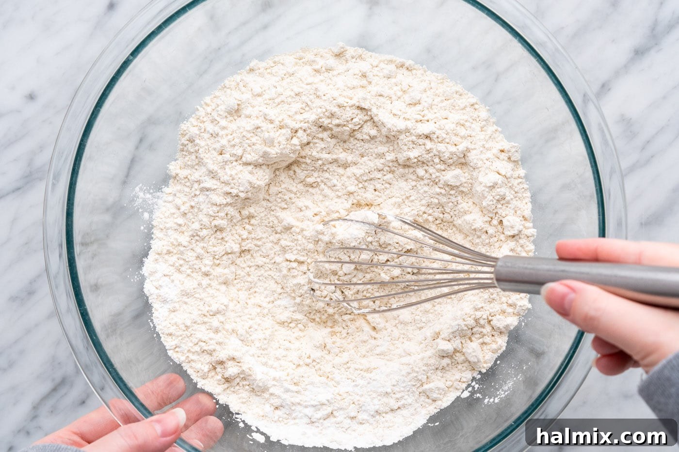 Whisking flour, baking powder, baking soda, and salt in a large bowl