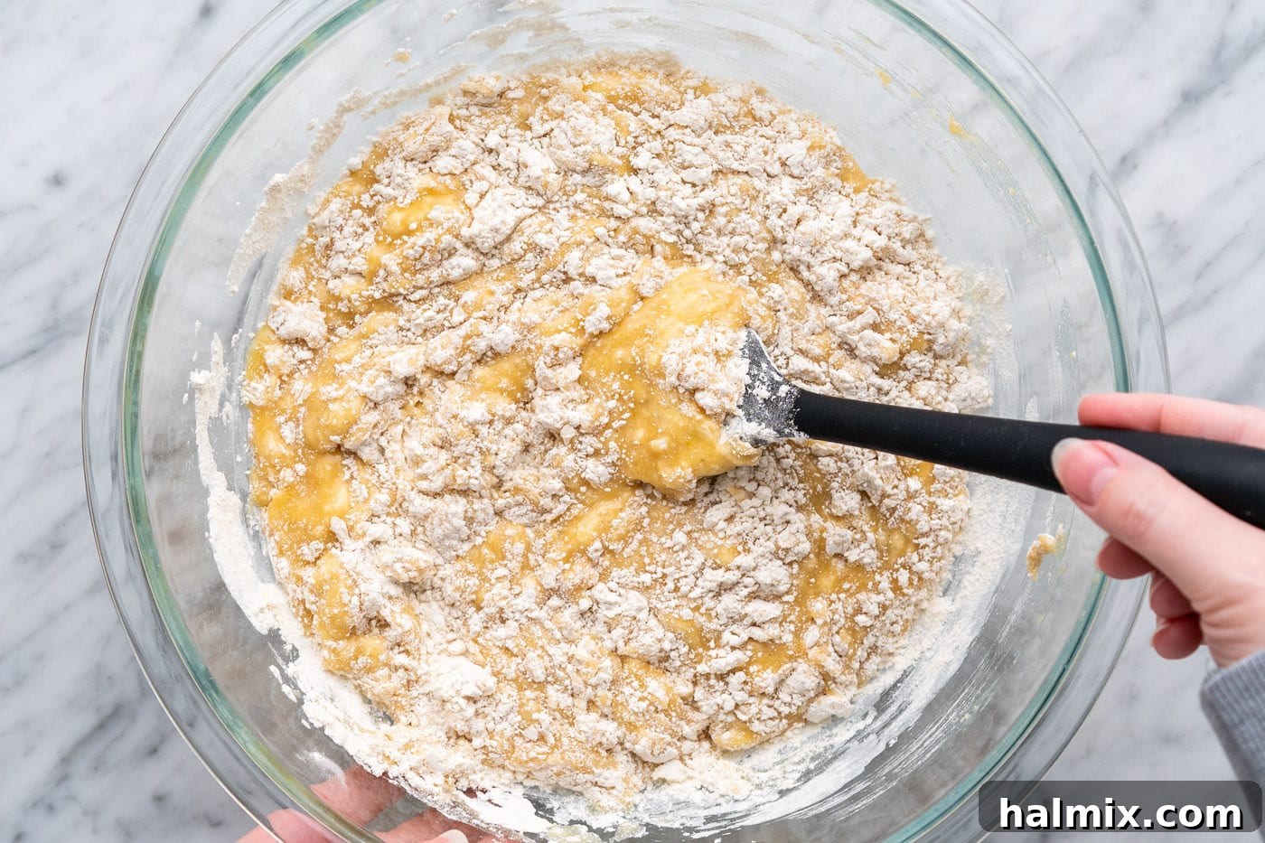 Folding and incorporating muffin batter together in a bowl