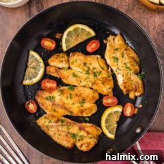 A close-up of a perfectly cooked orange roughy fillet, golden brown and flaky.