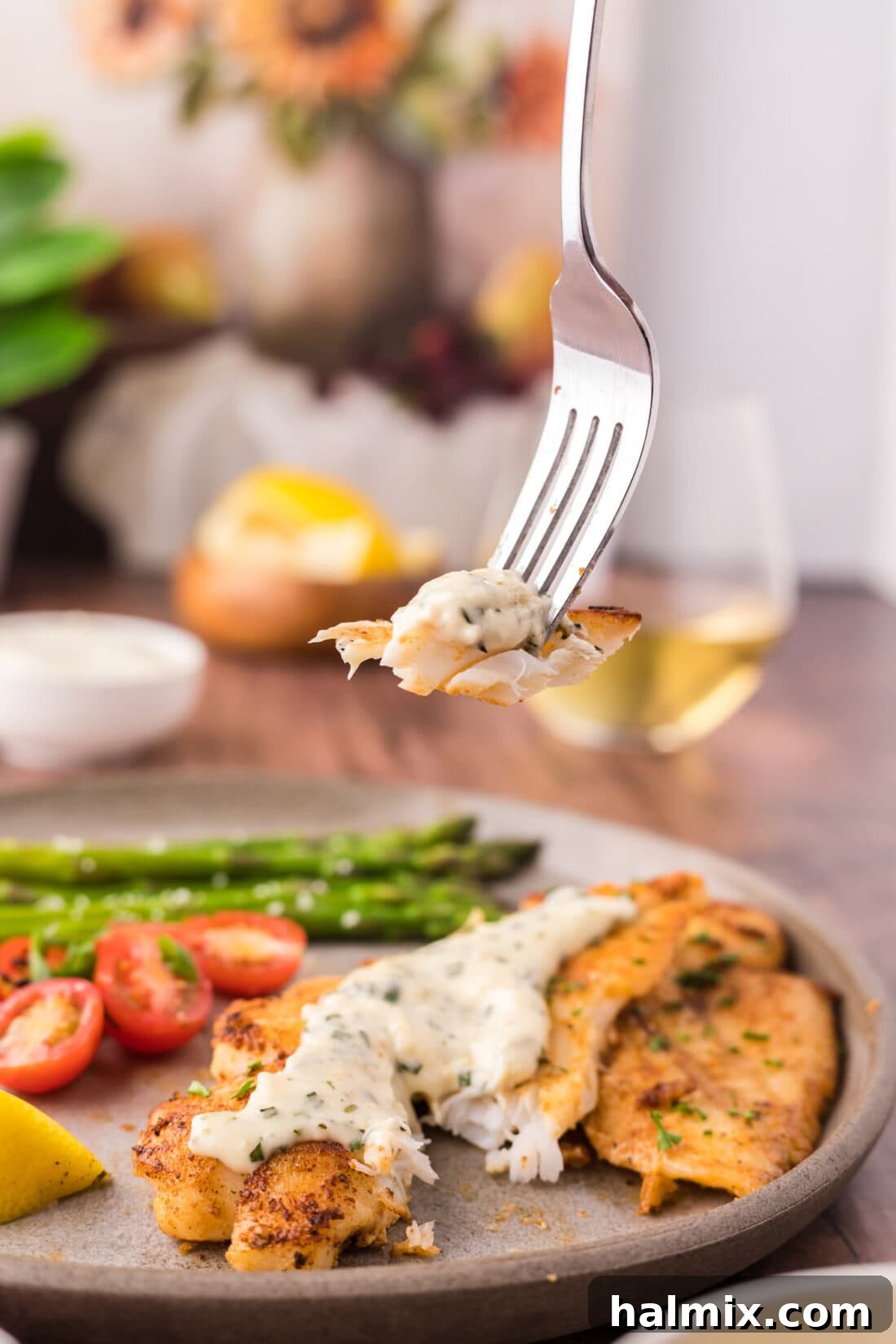 Ocean's Ancient Dweller 10 A close-up of a piece of orange roughy on a fork, showing its tender, flaky texture.