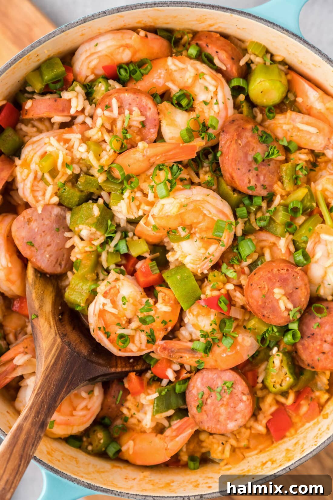 Bayou Blend 2 A steaming pot of classic Cajun Jambalaya, rich with rice, shrimp, and sausage, ready to be served with a large spoon inside.