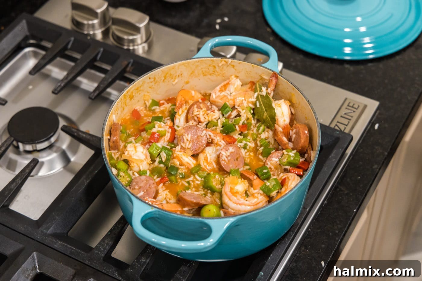 Bayou Blend 14 The fully mixed and heated jambalaya in a Dutch oven, showcasing its rich texture and vibrant colors.
