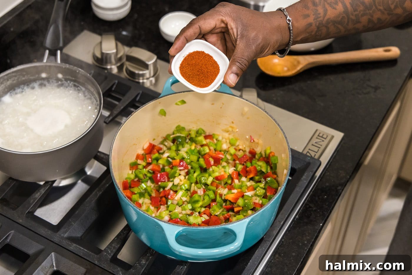 Bayou Blend 6 A close-up view of smoked paprika being added to sautéed vegetables in a Dutch oven, deepening their color and enhancing their aroma.