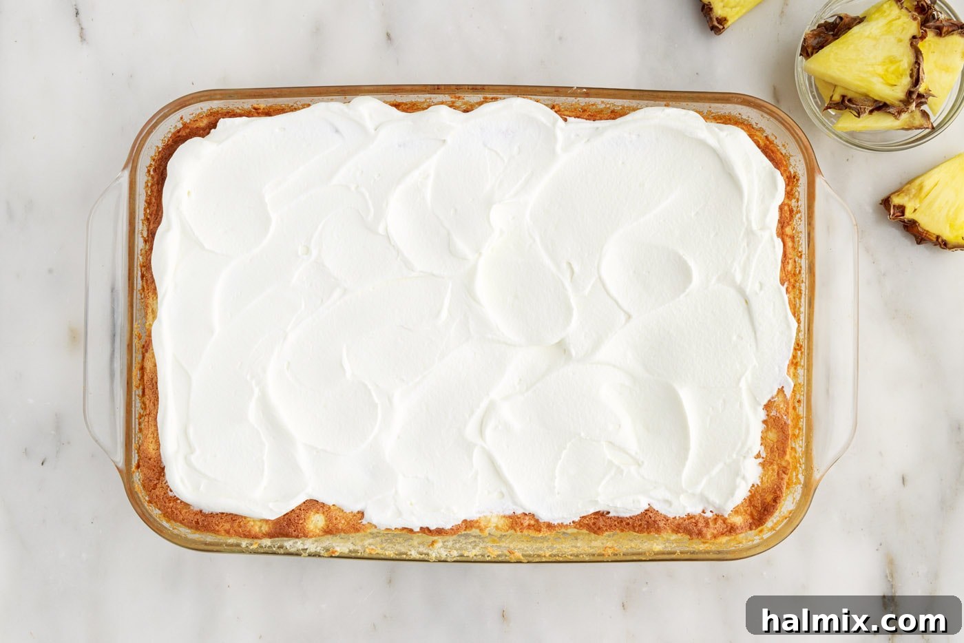 whipped cream on top of pineapple angel food cake