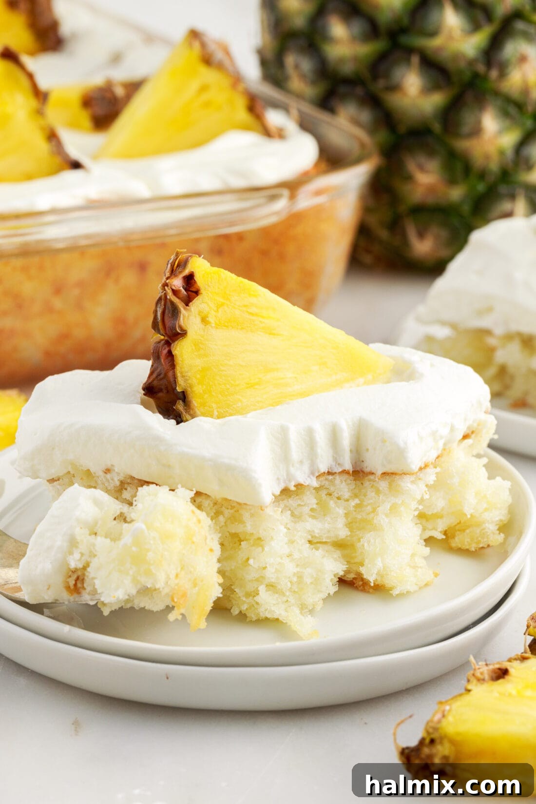 Square of Pineapple Angel Food Cake with a fork on the side