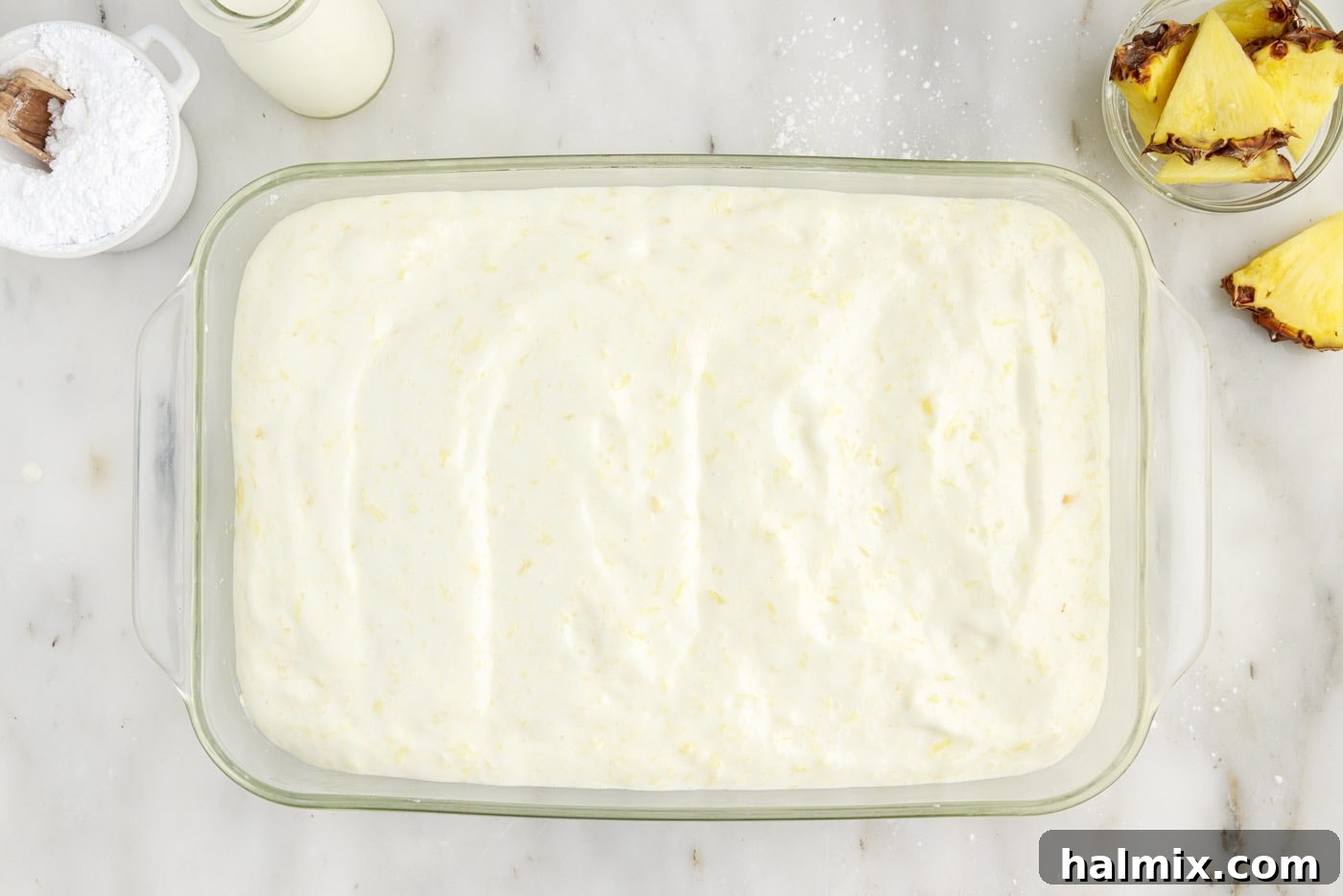 pineapple angel food cake batter in a 9x13 baking dish