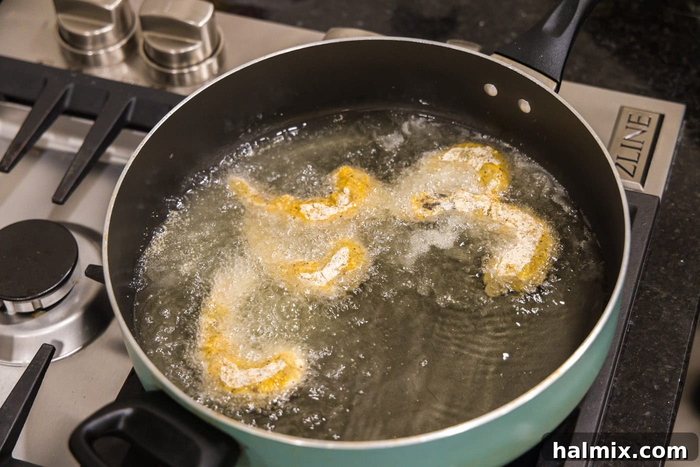 Golden Crispy Shrimp 12 frying breaded shrimp in a skillet of oil