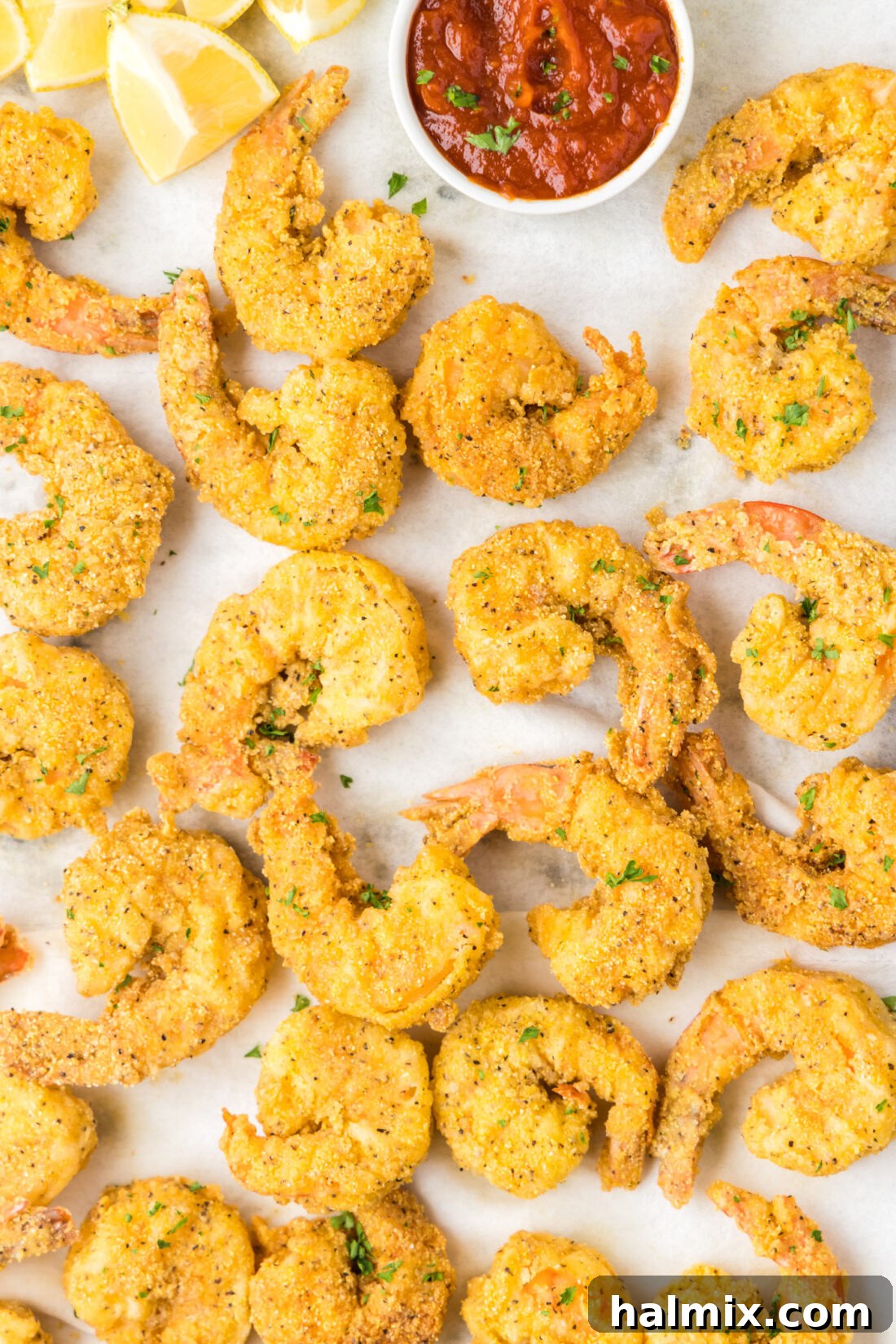 Golden Crispy Shrimp 3 Close up of a pan of Fried Shrimp with a bowl of cocktail sauce