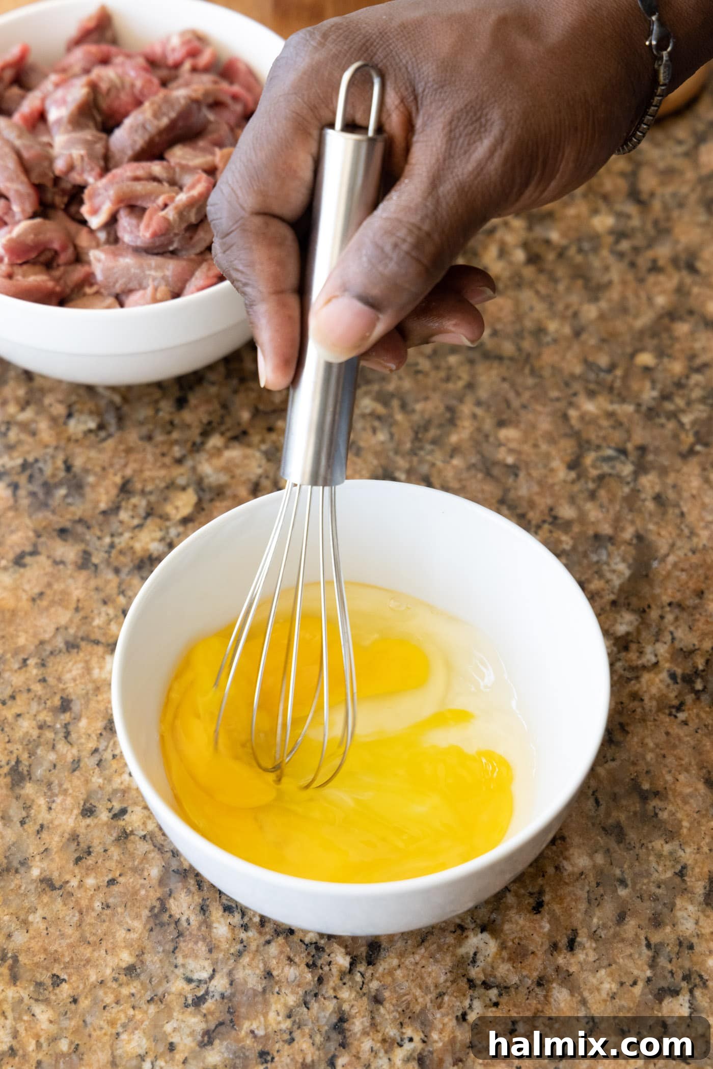 whisking egg in a bowl