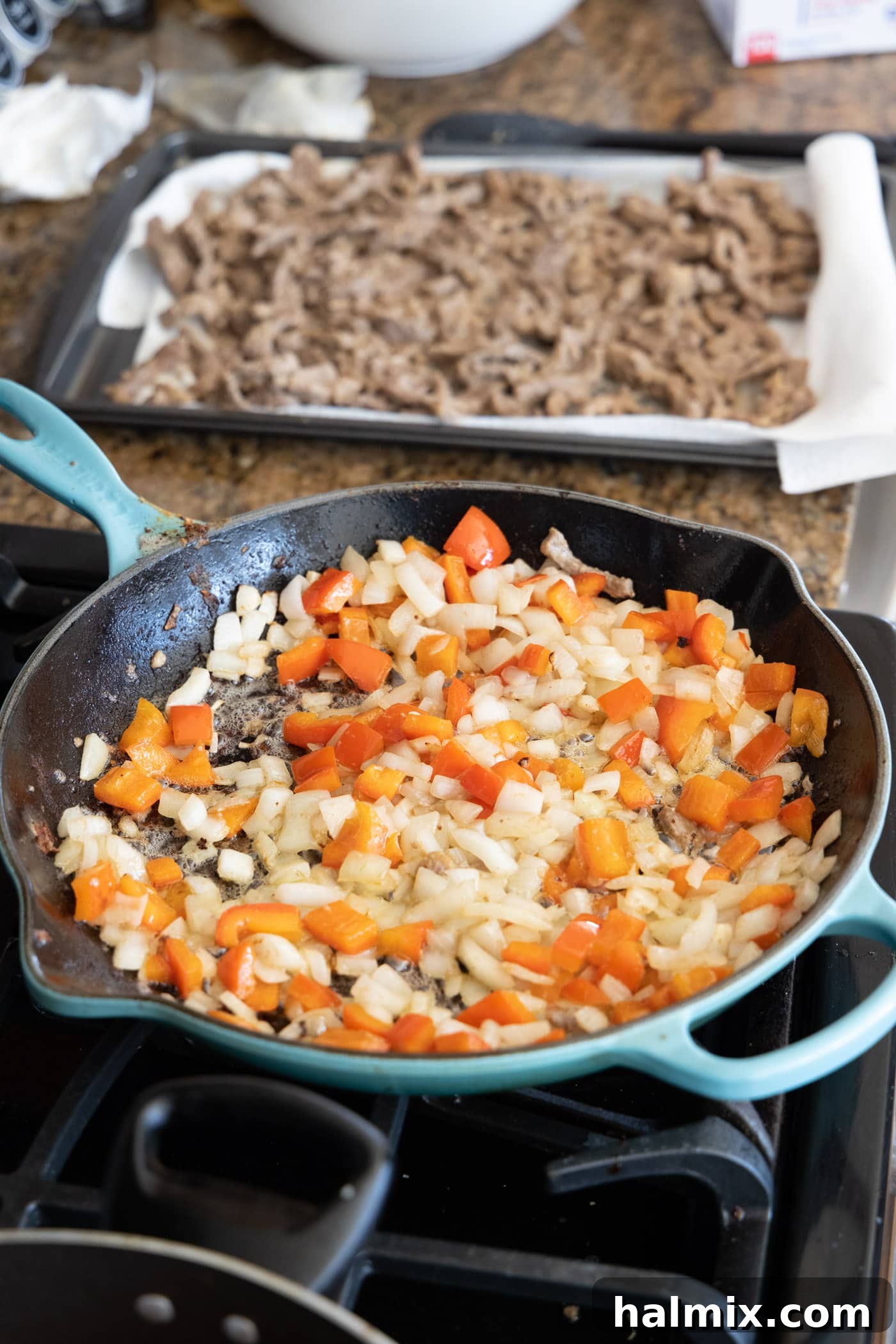 stir fried onion and bell pepper in a skillet