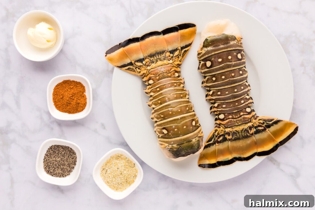 All the fresh ingredients laid out: lobster tails, softened butter, black pepper, garlic salt, and Old Bay seasoning.