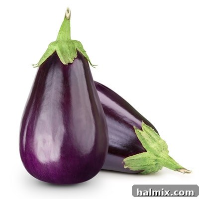 Low Carb Vegetables: Your Essential Guide to What to Eat and What to Skip 12 A dark purple eggplant isolated on a white background.