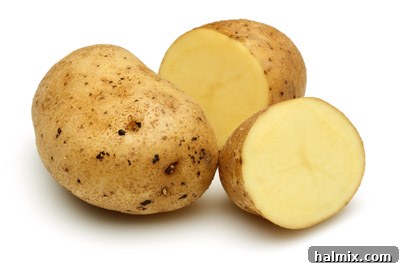 Low Carb Vegetables: Your Essential Guide to What to Eat and What to Skip 19 A group of whole potatoes and sliced half potatoes.