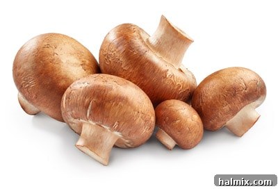 Low Carb Vegetables: Your Essential Guide to What to Eat and What to Skip 6 A cluster of fresh white champignon mushrooms.