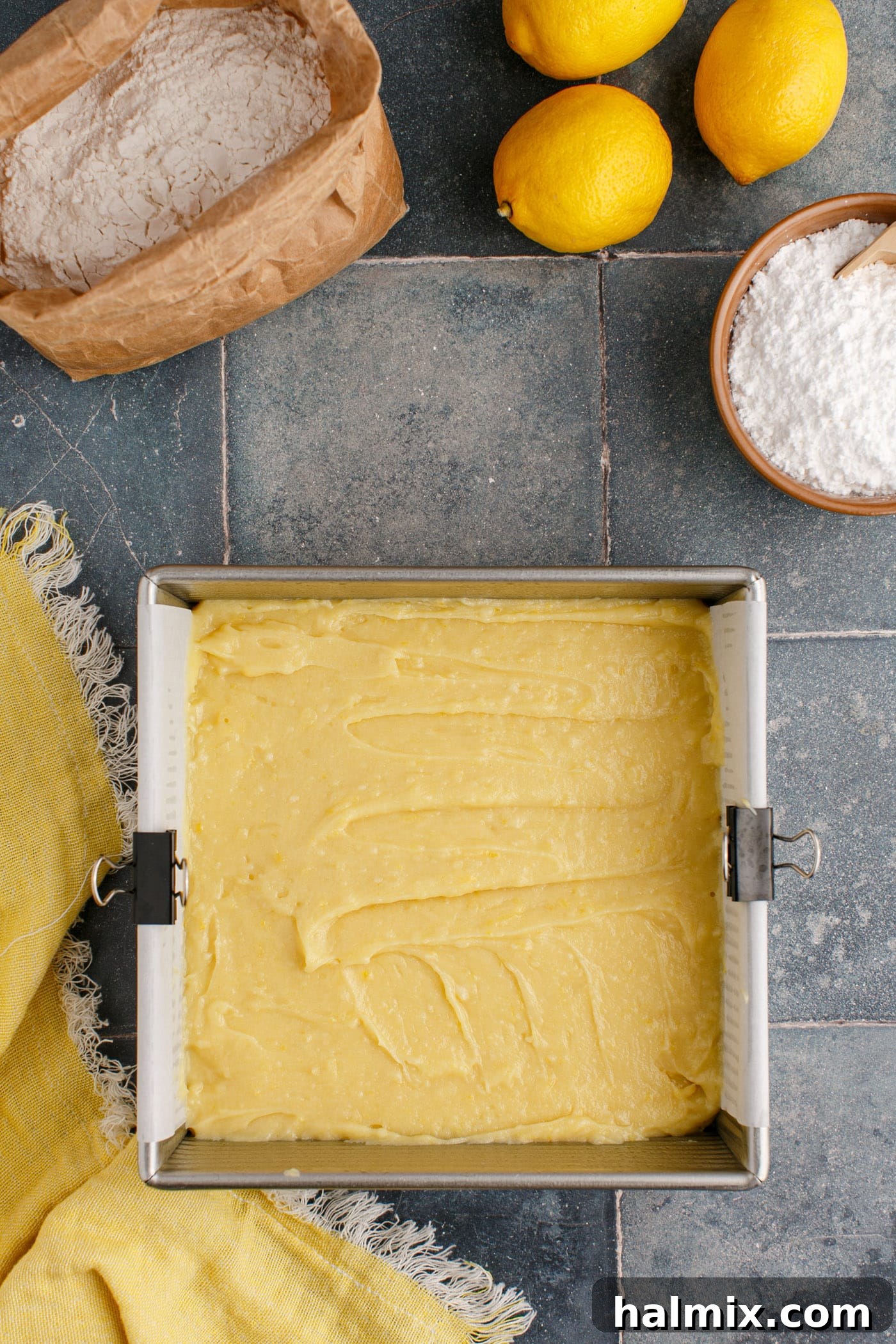 Smooth lemon brownie batter spread evenly in a baking pan, ready for the oven.
