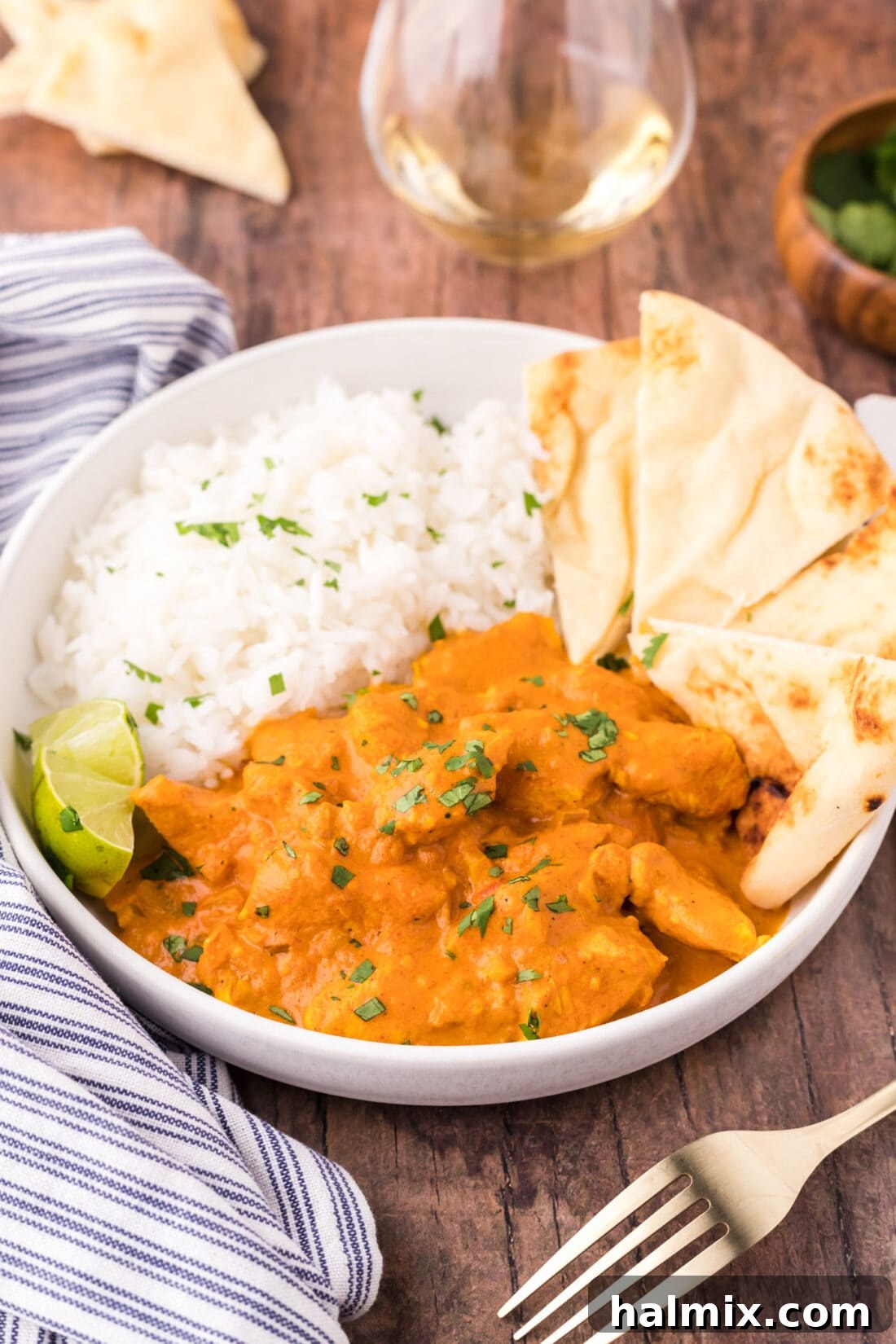 Bowl of Chicken Tikka Masala with rice and naan bread