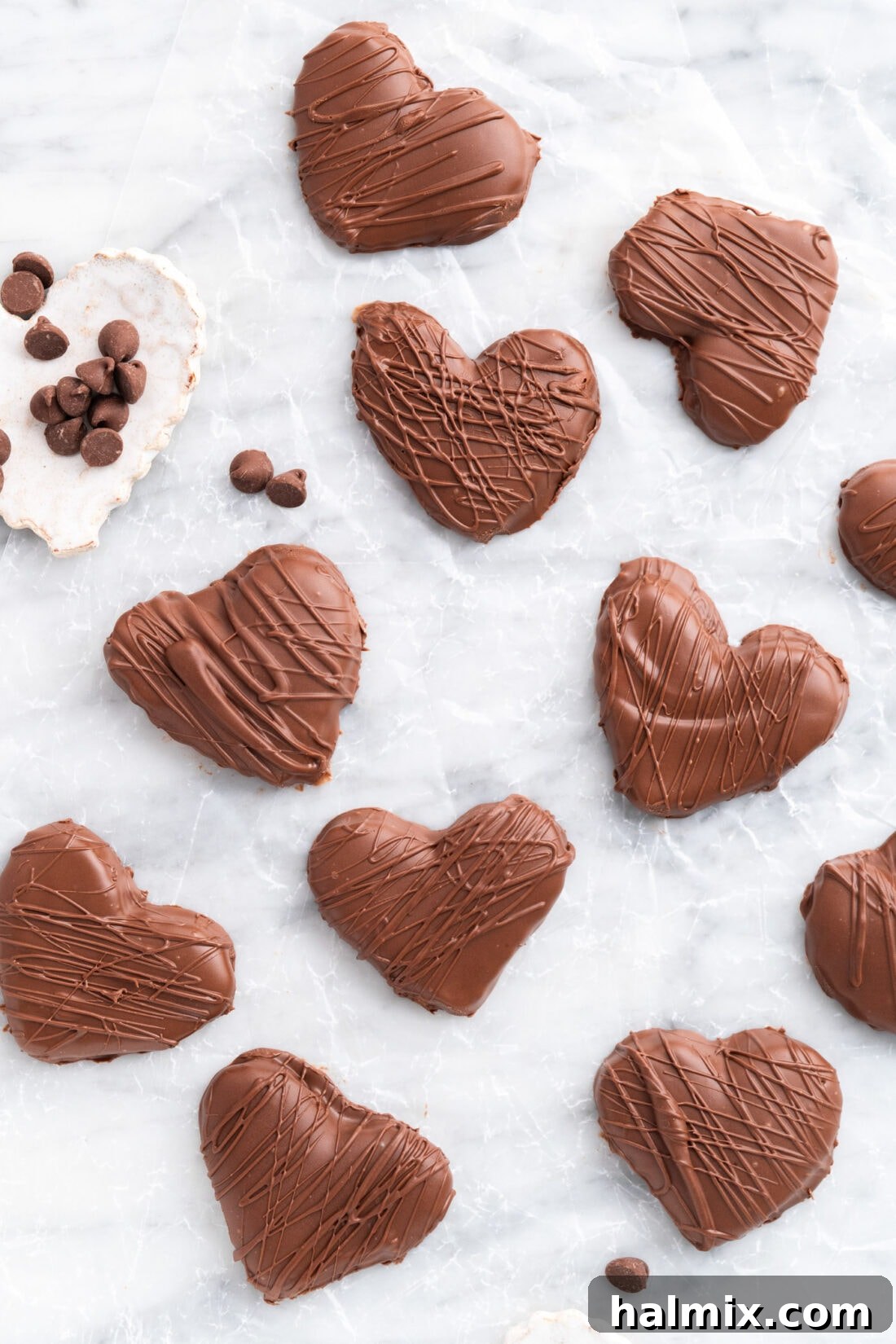 Sweetheart Chocolate Peanut Butter Treats 2 Delightful Chocolate Peanut Butter Hearts arranged on parchment paper, sprinkled with chocolate chips for a festive touch.