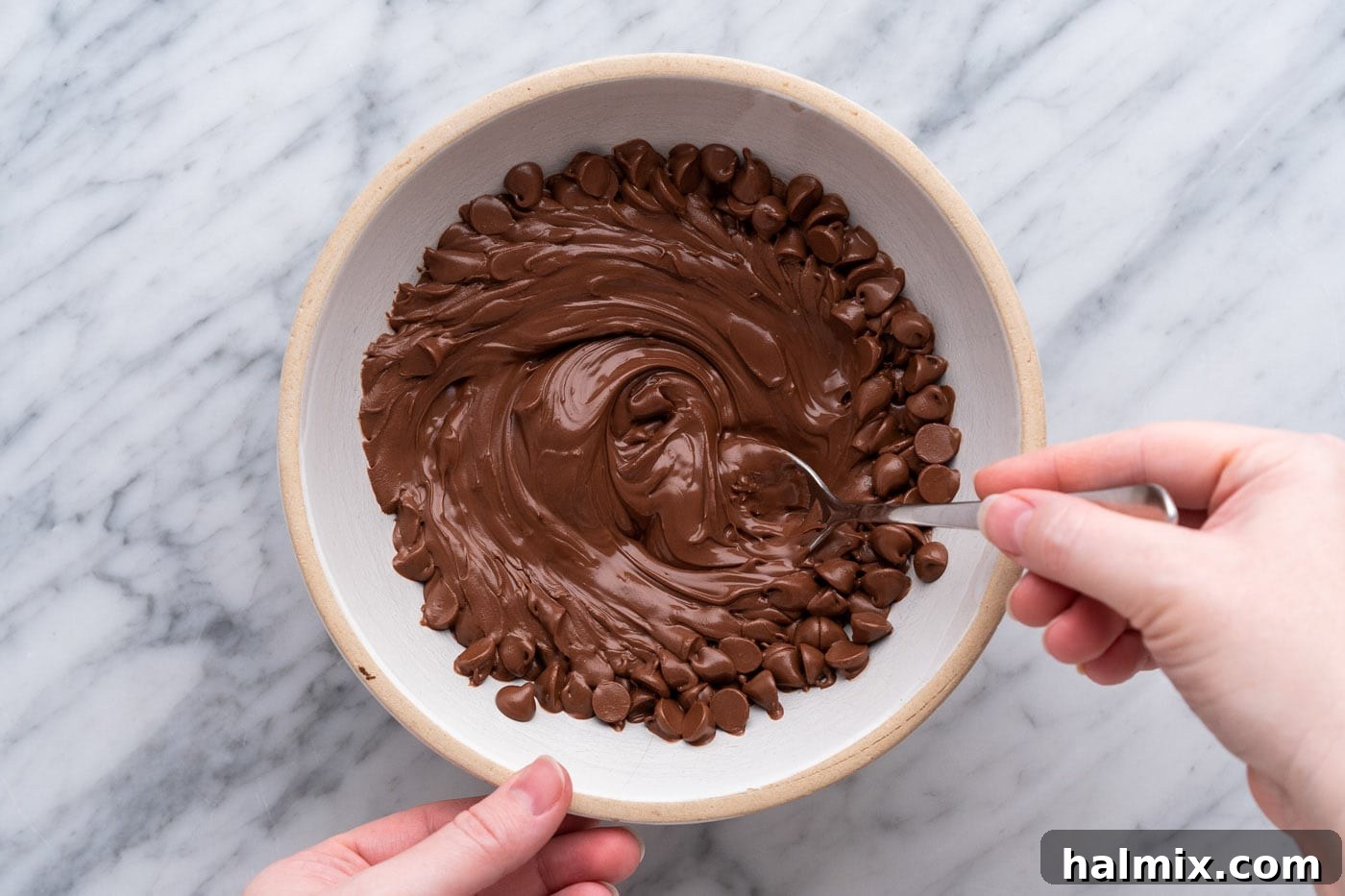 Sweetheart Chocolate Peanut Butter Treats 12 stirring melted chocolate chips in a bowl