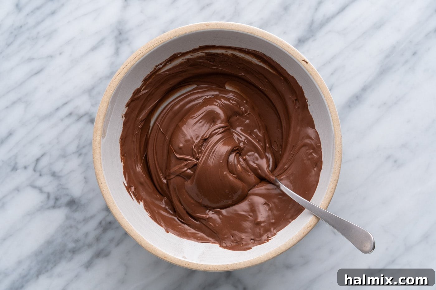 Sweetheart Chocolate Peanut Butter Treats 13 melted chocolate in a bowl with a spoon