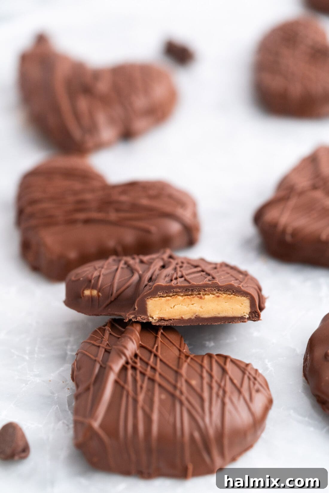 Sweetheart Chocolate Peanut Butter Treats 3 A close-up view of a Chocolate Peanut Butter Heart with a small bite taken out, revealing its creamy peanut butter center.