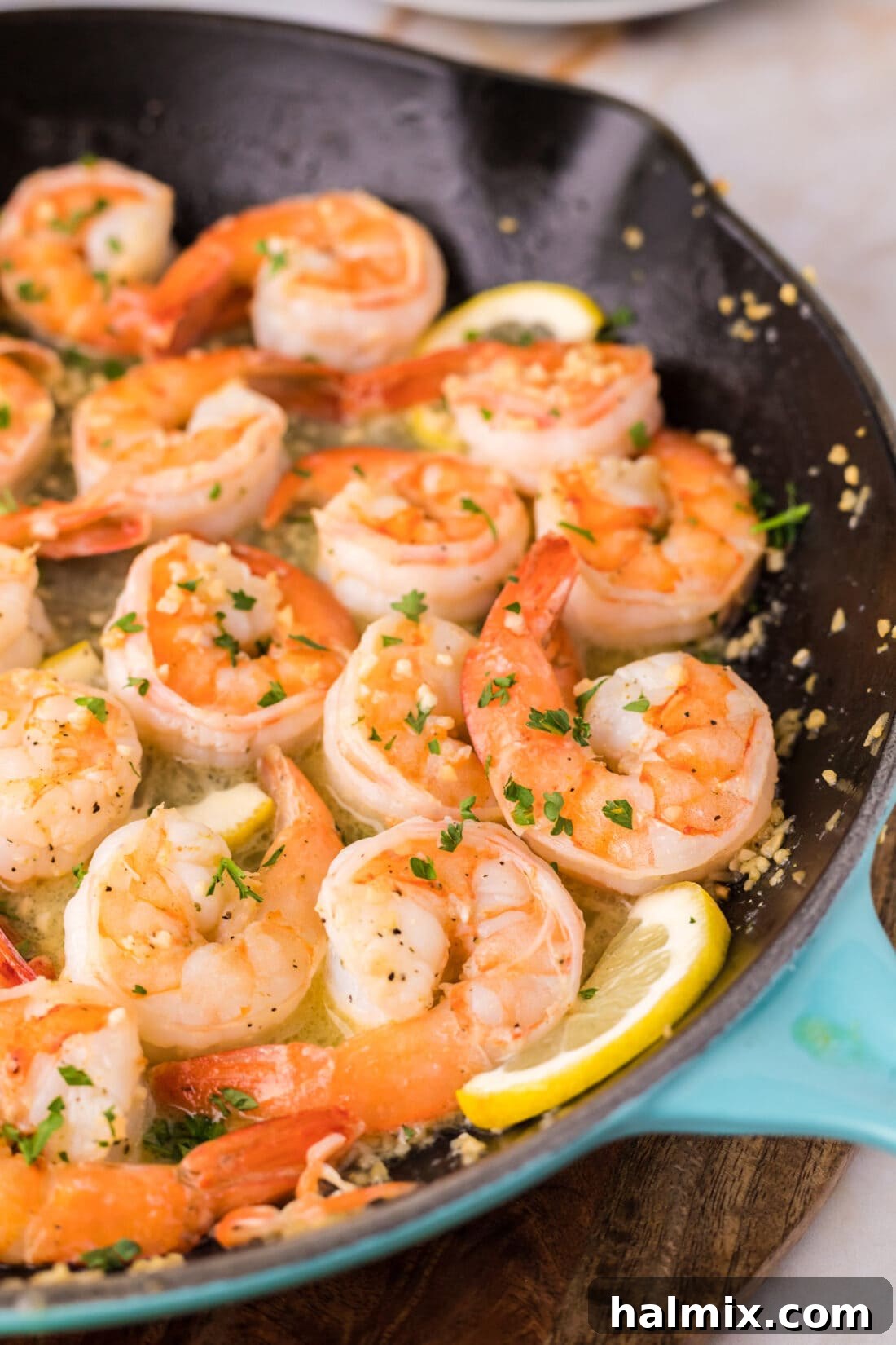 Close up of perfectly cooked Garlic Butter Shrimp in a shimmering skillet
