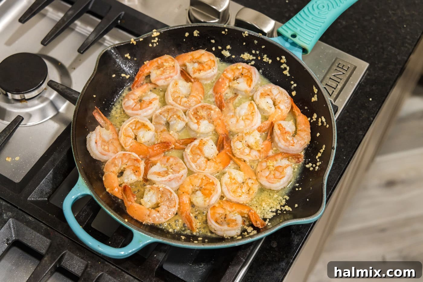 Close up of cooked shrimp glistening in lemon garlic butter sauce