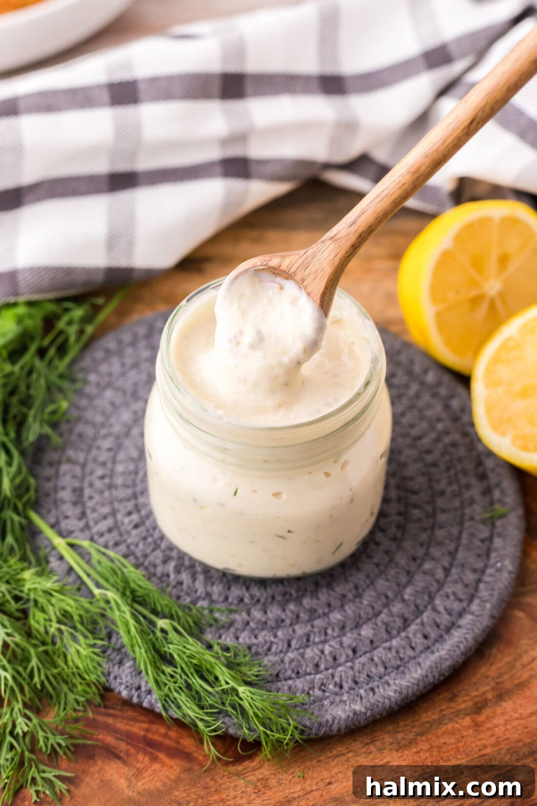 Zest for the Catch 3 Spoonful of creamy homemade tartar sauce being scooped from a jar