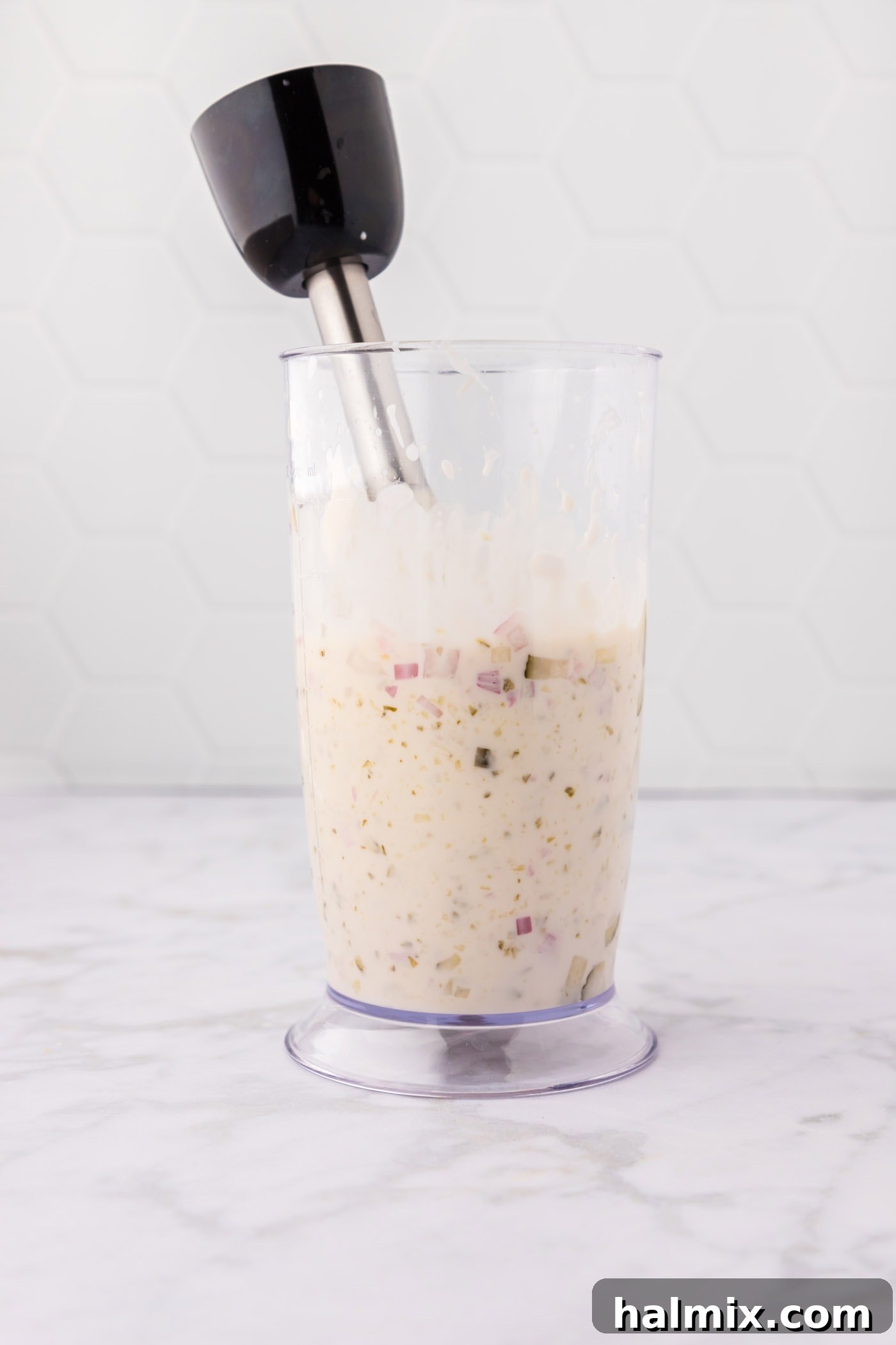Zest for the Catch 6 Tartar sauce ingredients being blended with an immersion blender