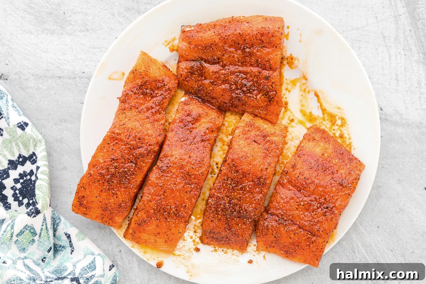 salmon filets coated in seasonings on a plate