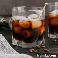 Black Russian in a rocks glass with another Black Russian behind it, perfectly chilled