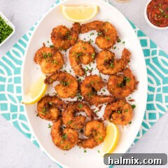 Coconut Shrimp on a platter with lemon wedges for garnish
