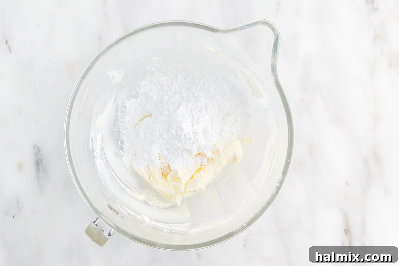Festive Sprinkle Cake 14 powdered sugar added to butter in a stand mixer bowl