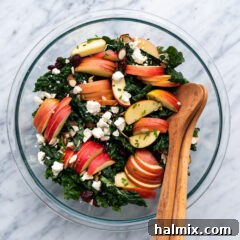 Bowl of Kale Salad with serving spoons in the bowl