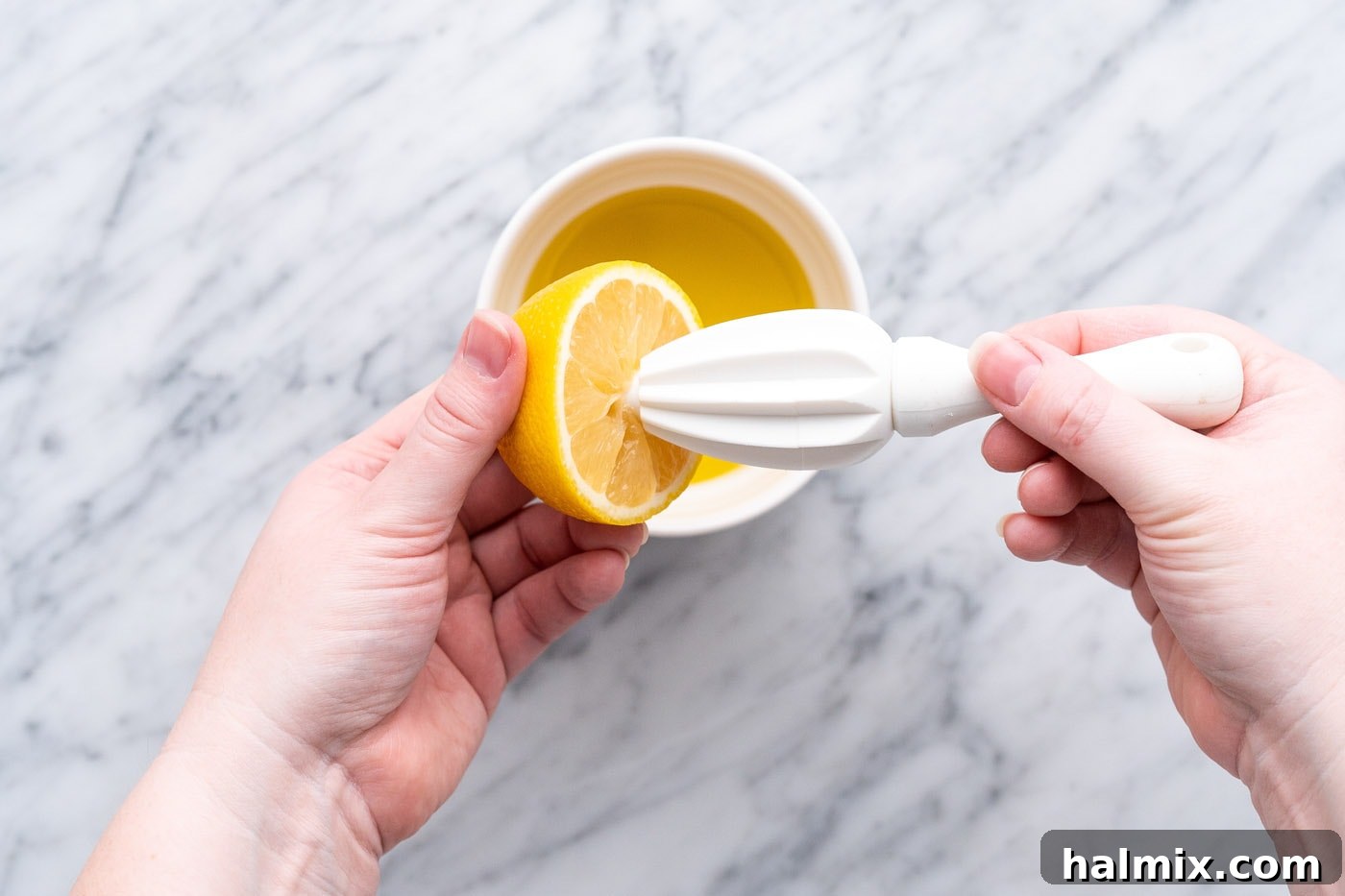 Squeezing fresh lemon juice into a bowl