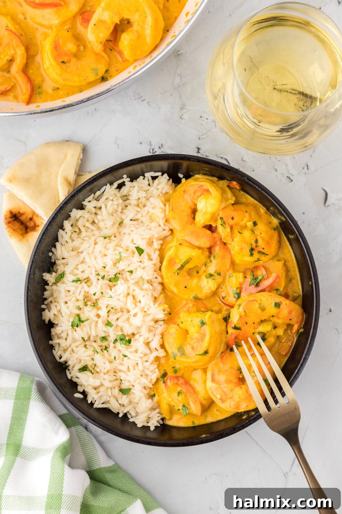 Vibrant Shrimp Curry 12 A beautifully presented bowl of creamy shrimp curry, garnished with fresh herbs and served alongside a bed of fluffy white rice, ready to be enjoyed.