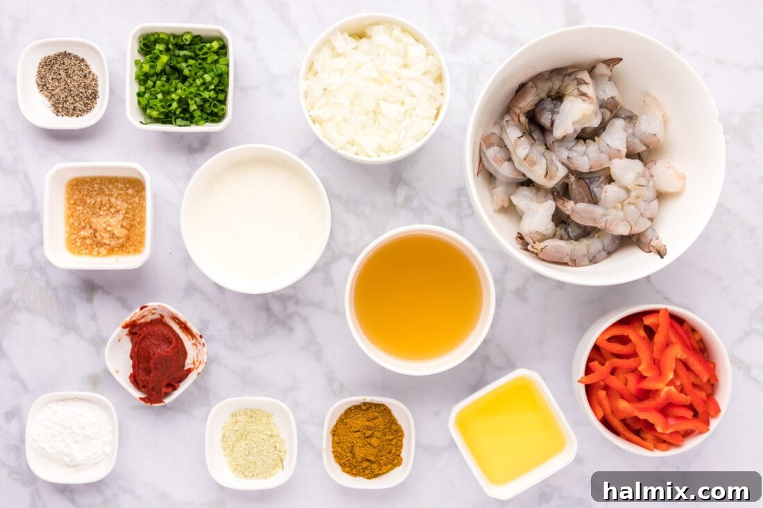 Vibrant Shrimp Curry 4 A flat lay photograph displaying all the fresh ingredients and spices required to make the shrimp curry: shrimp, bell peppers, onions, garlic, green onions, and various spices.