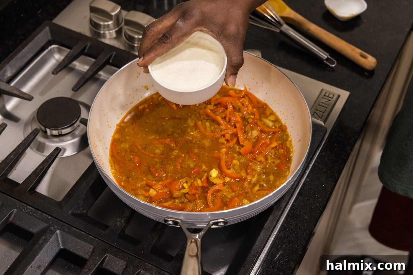 Vibrant Shrimp Curry 8 adding heavy cream to skillet with curry gravy