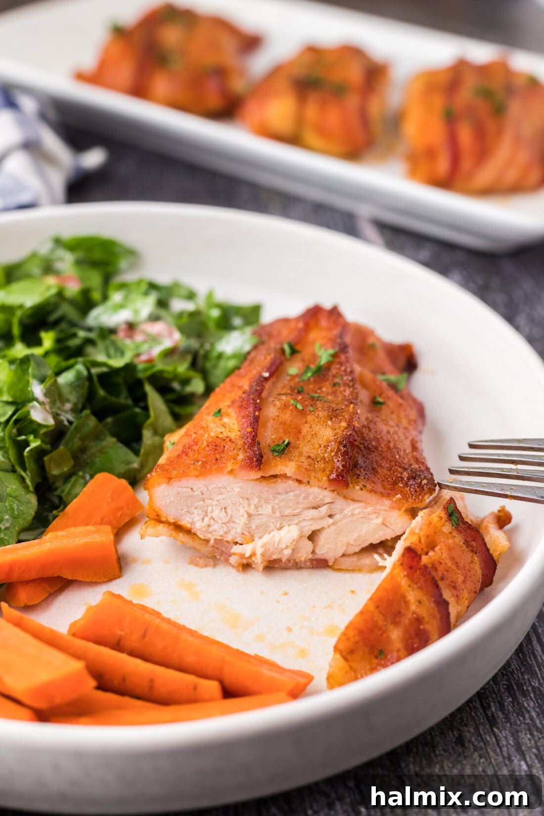 Crispy Bacon Chicken Bundles 3 Bacon Wrapped Chicken on a plate cut open to show juicy interior