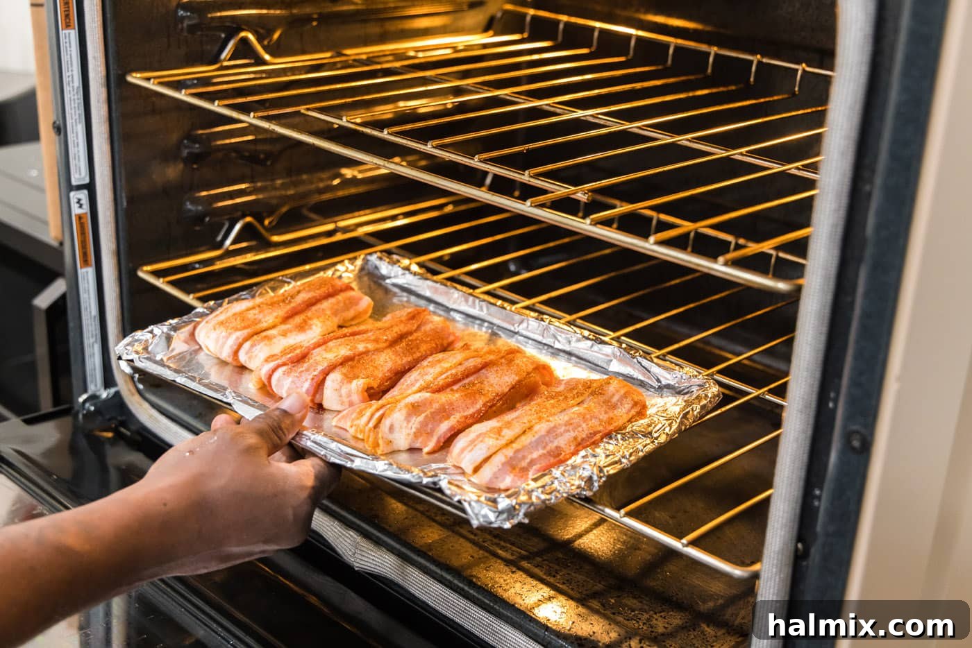 Crispy Bacon Chicken Bundles 9 oven baked bacon wrapped chicken on a baking sheet