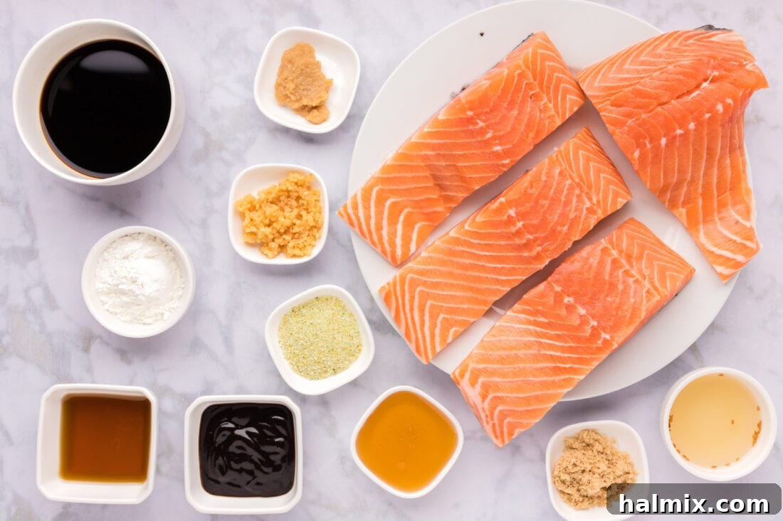 Array of ingredients for homemade teriyaki salmon marinade including soy sauce, honey, ginger, and garlic