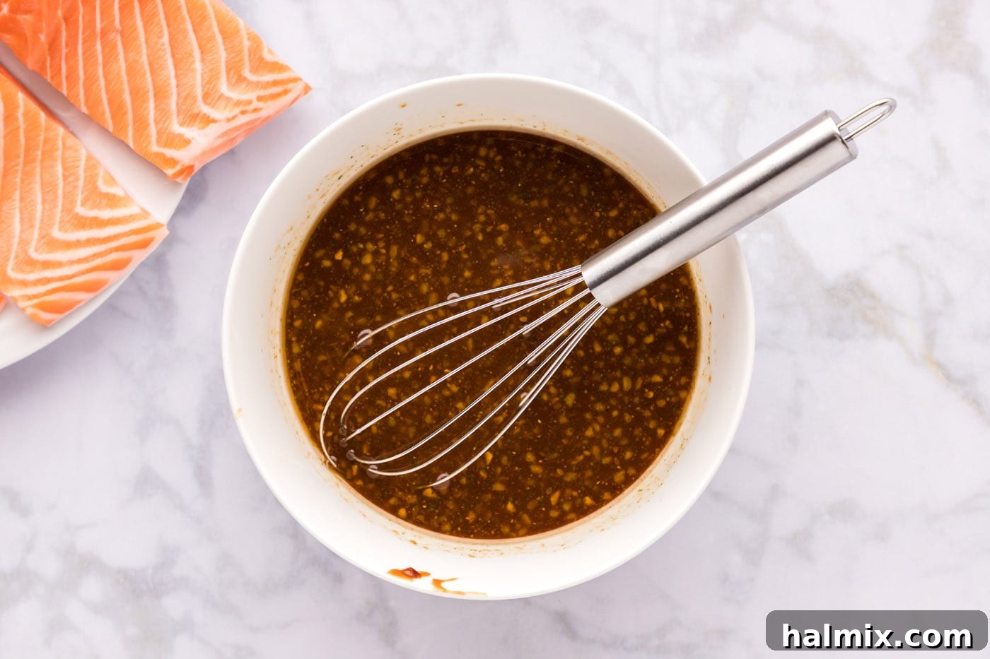 Homemade teriyaki sauce being whisked in a bowl