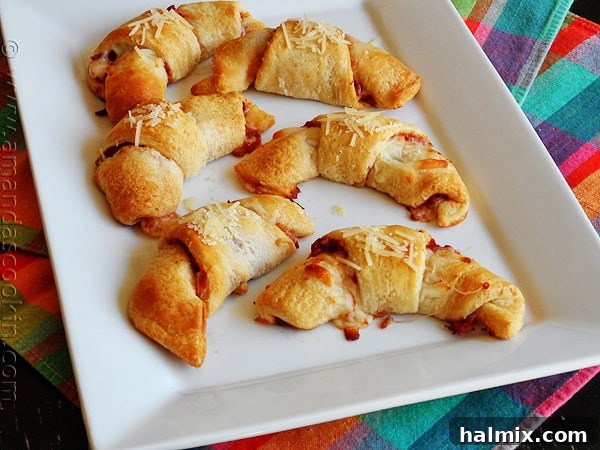 Cheesy Pizza Crescent Pinwheels 7 An overhead photo of pizza crescent roll ups on a white platter.
