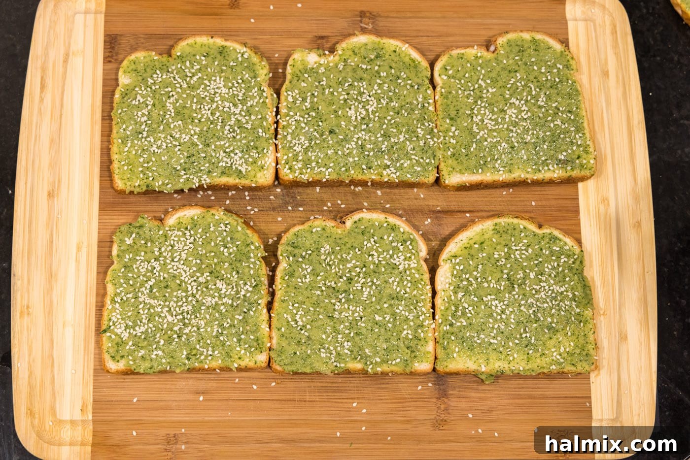 Crispy Golden Shrimp Toast 8 Sprinkling sesame seeds over the shrimp paste on bread slices