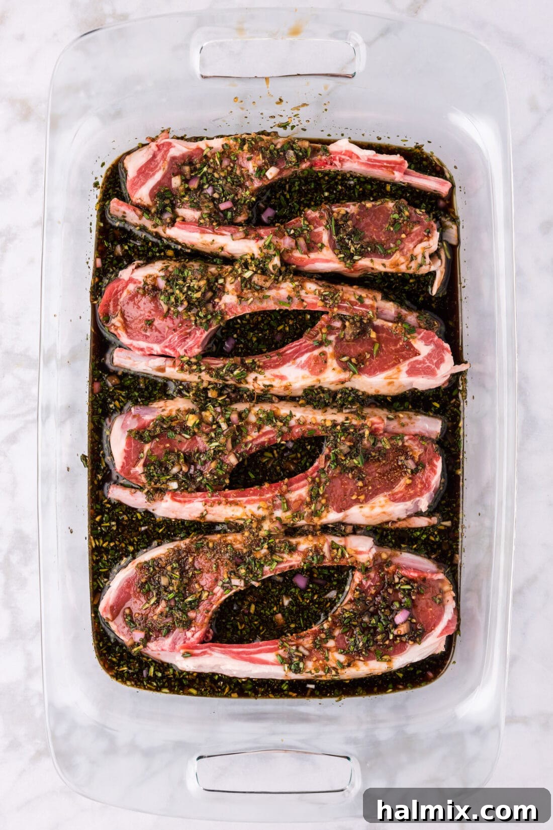 Ultimate Lamb Chop Marinade 2 Lamb Chops and Lamb Chop Marinade sitting in a 13 x 9 pan