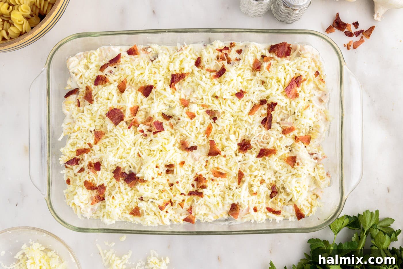crumbled bacon on top of cream cheese and chicken pasta casserole