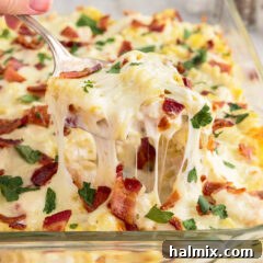 Spoonful of Chicken Bacon Ranch Casserole being lifted out of a casserole dish